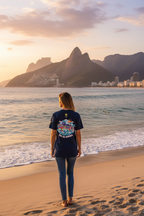 Person standing on a beach with mountains and city skyline in the background