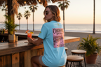 woman at beach bar with coronado graphic t-shirt