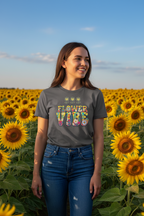 Woman wearing a 'Flower Vibe' t-shirt standing in a sunflower field.