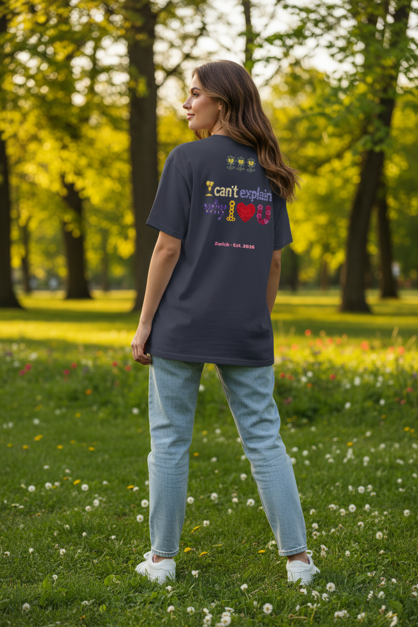 Person wearing a dark blue t-shirt with text and graphics in a park