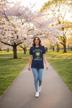 Woman walking on a path lined with cherry blossom trees in full bloom
