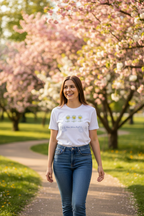 Woman walking on a path with cherry blossom trees in the background