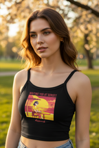Woman wearing a black tank top with a graphic design in a park